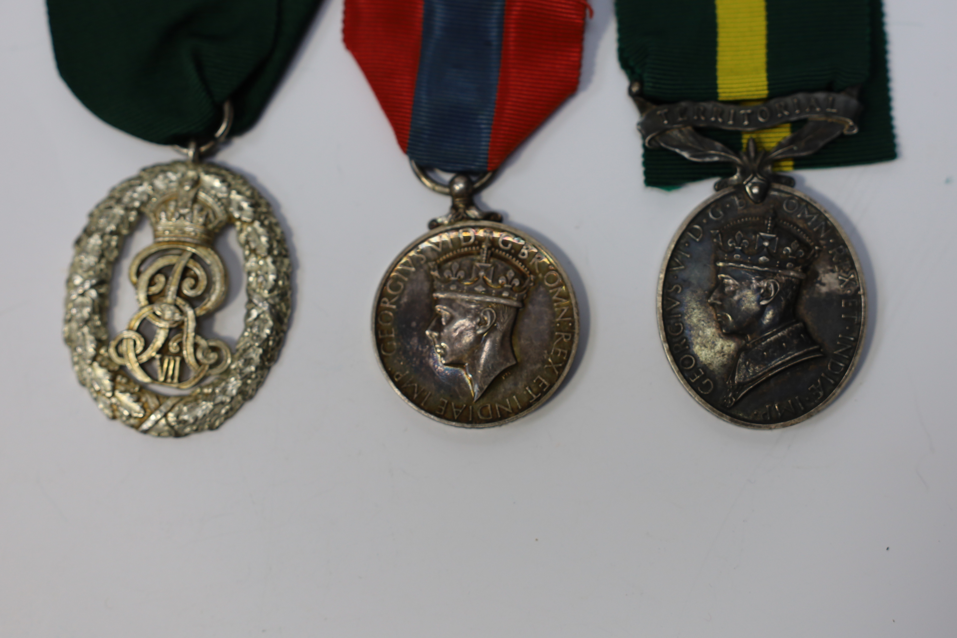 Three assorted service medals; Ed VII Volunteer Officer's Decoration hallmarked for 1905; GV Imperial Service medal to Walter Charles Cornish; GVI Territorial Efficiency medal to 2062789 . S/Sgt. L.W.Sergeant. R.A. Condi